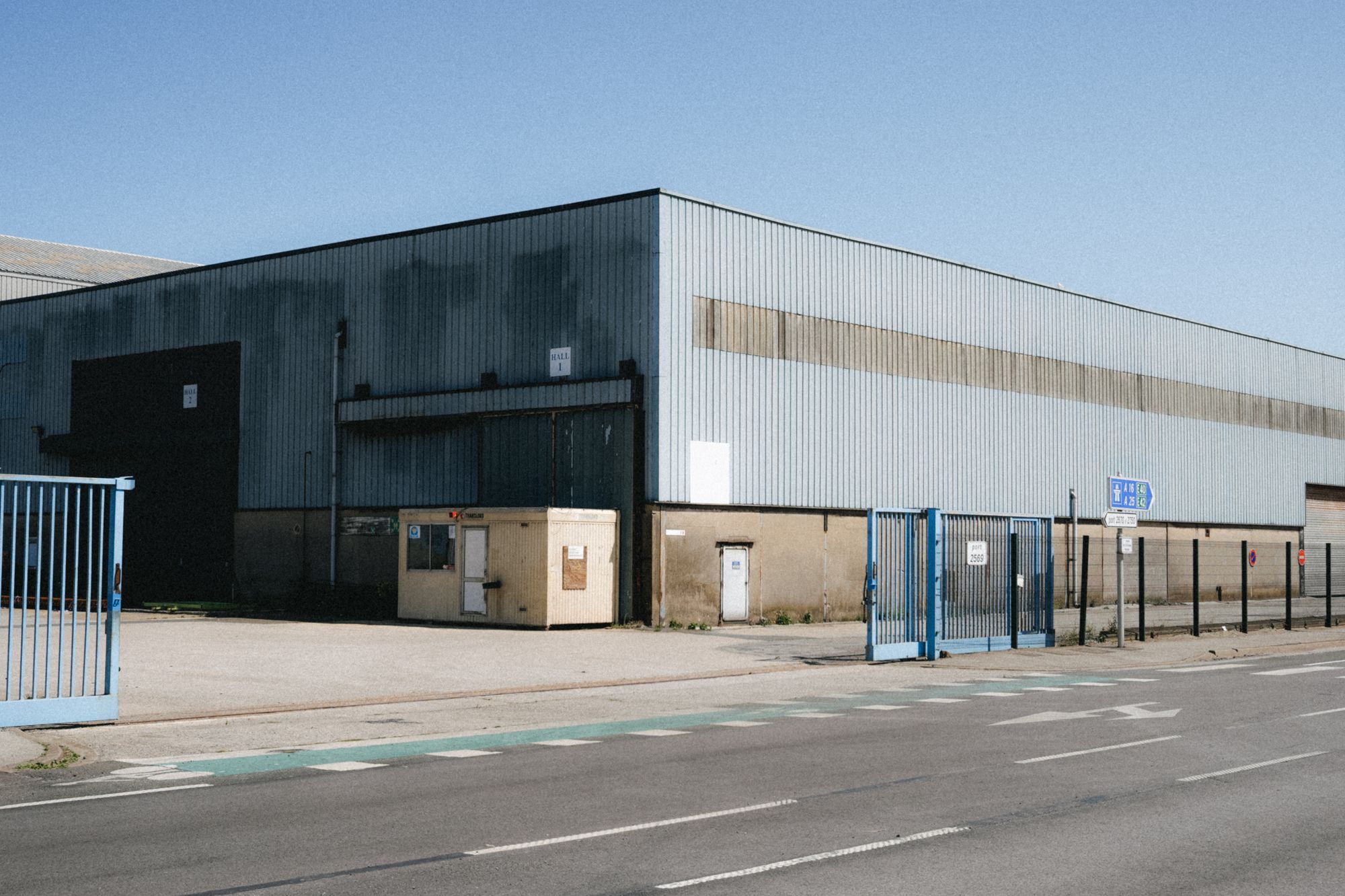 Illustrative photograph of a metal industrial warehouse. Not a 419 project.